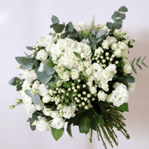 white hydrangea, white spray roses, white hypericum and eustoma in a bouquet