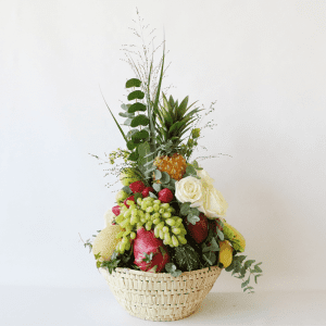 Luxurious fruit basket full of pineapples, grapes, melon, banana