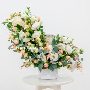 Pink and white flower arrangement with a candle