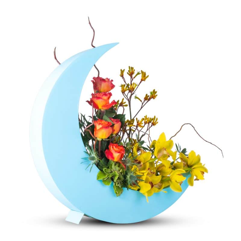 Flower Arrangement In a Blue Half Moon