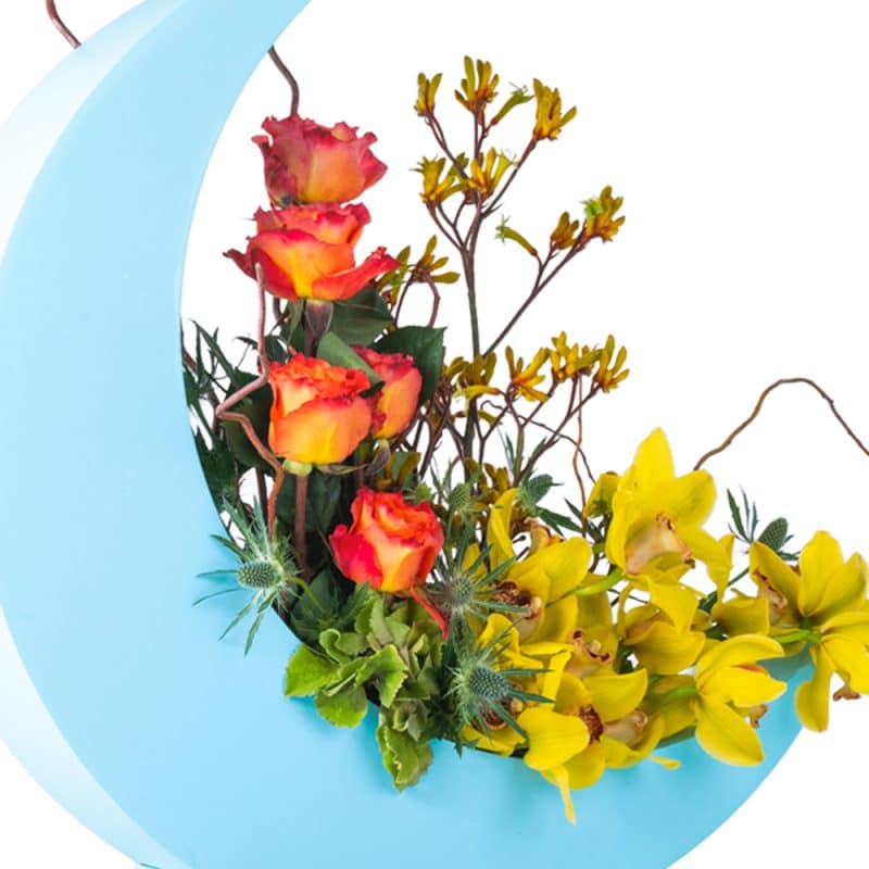 Flower Arrangement In a Blue Half Moon